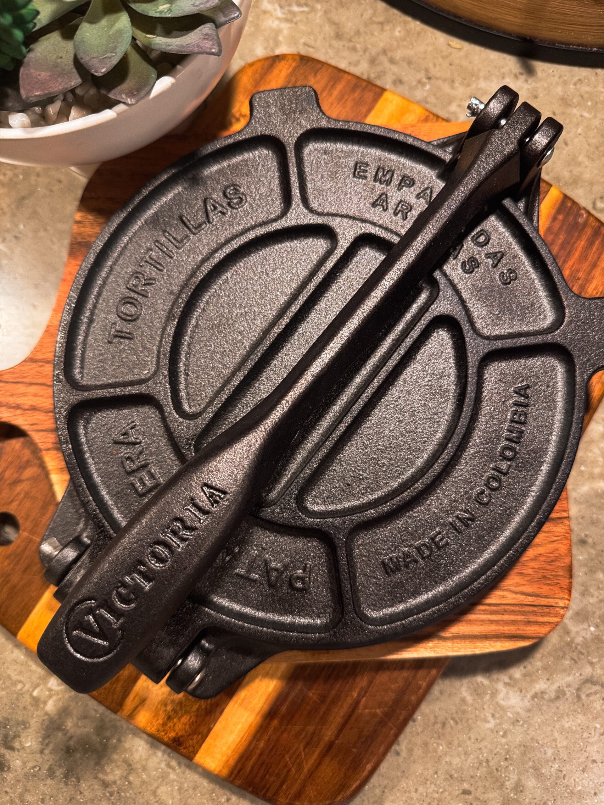 a cast iron waffle iron on a wood surface