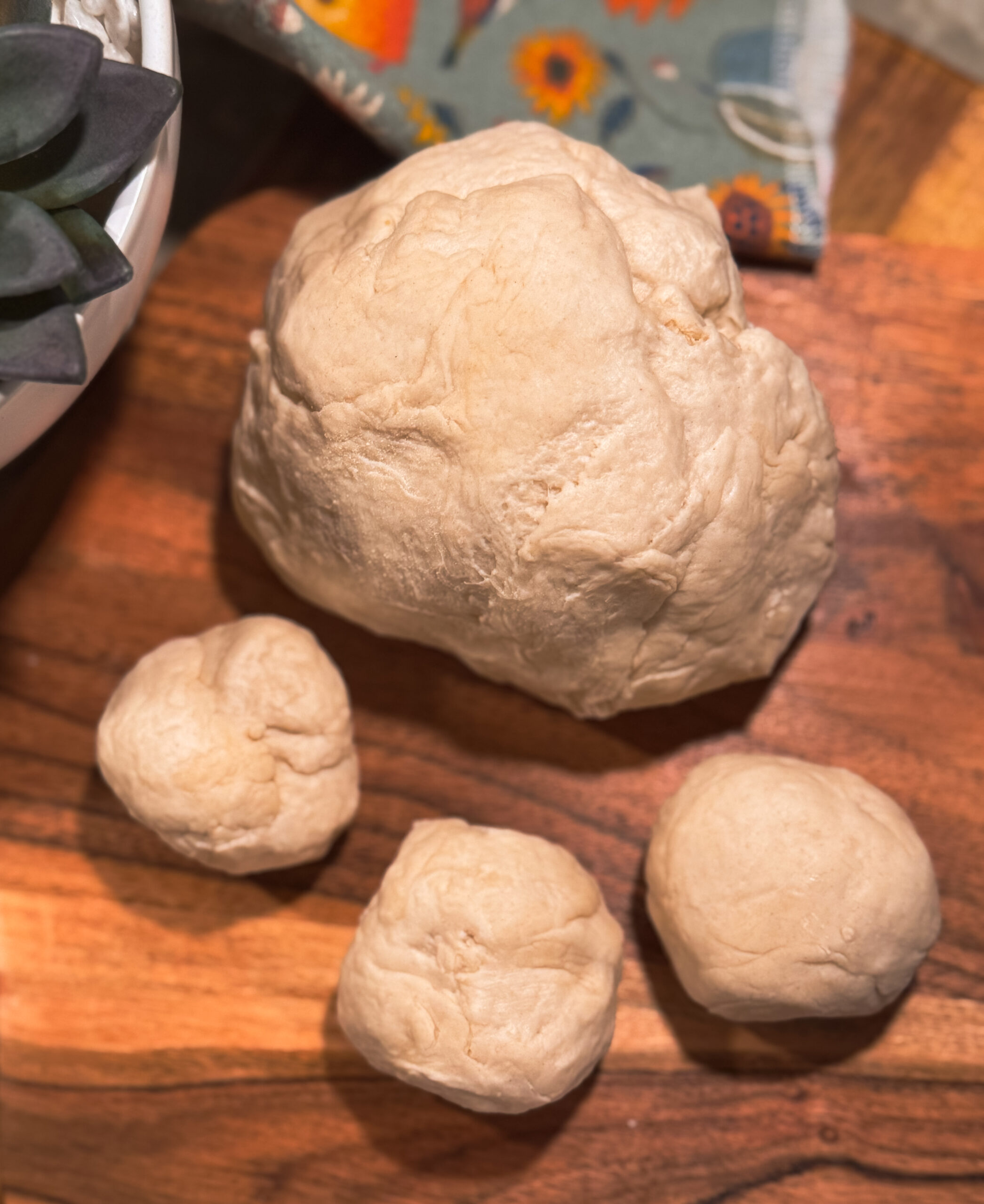 a ball of dough on a wooden surface