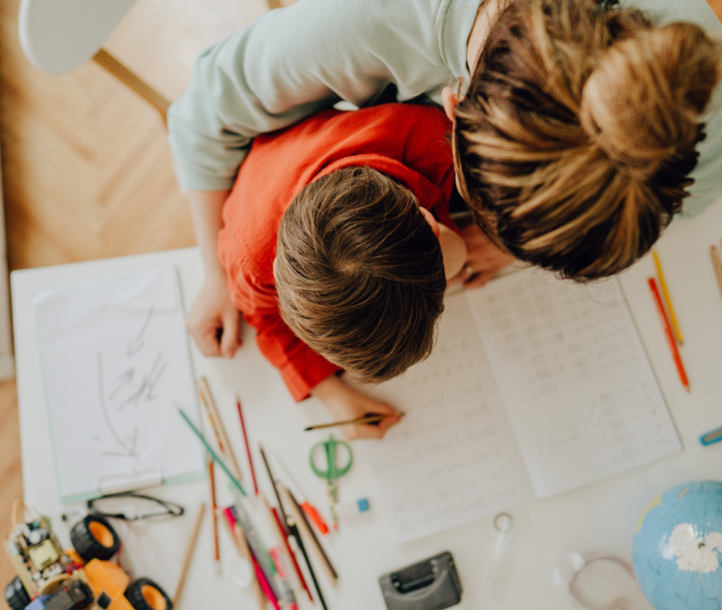 a woman and a child looking at a paper