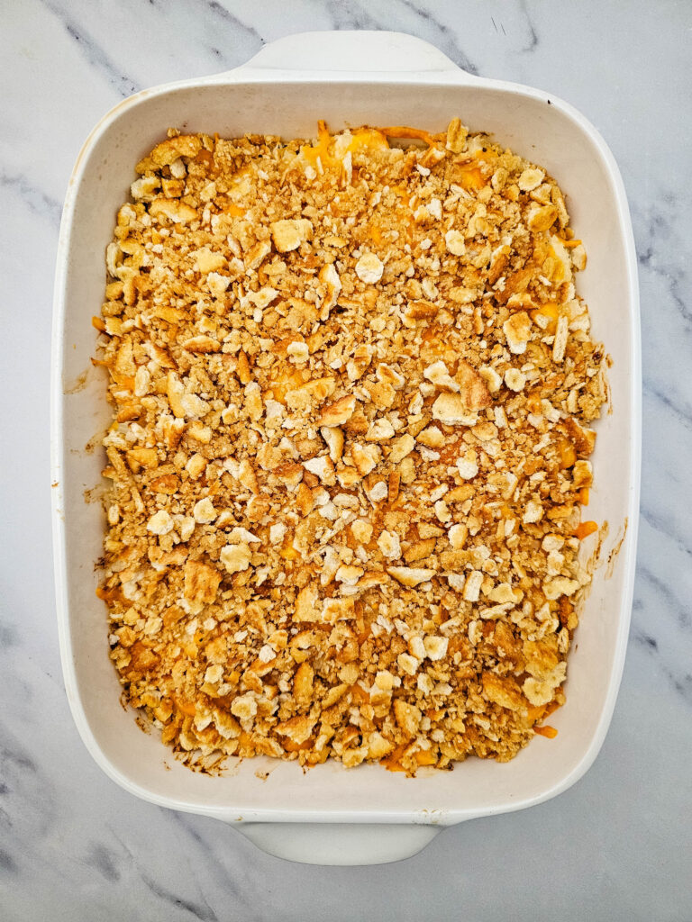 Baked potato casserole topped with a golden crushed cracker topping.